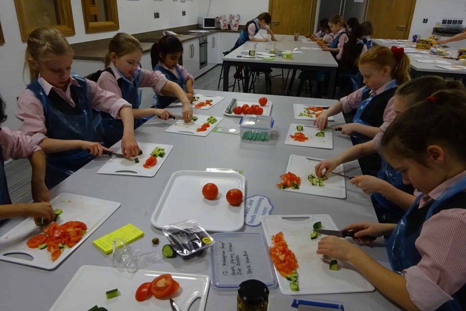 Fairfield children cutting vegetables in the cookery room