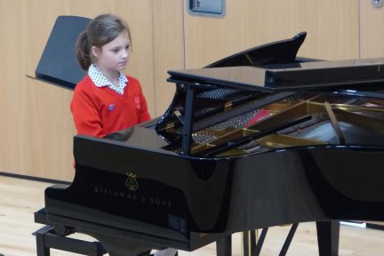 Fairfield pupil playing the steinway piano
