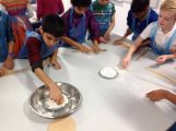 Fairfield children making dough in the cookery room