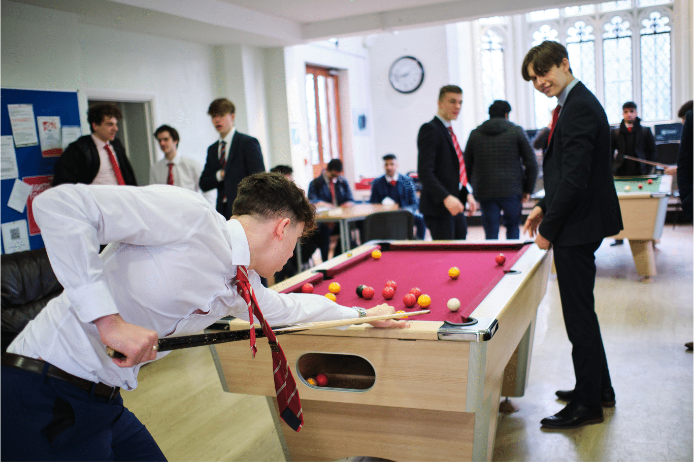 Two students playing pool in the Sixth Form Centre.